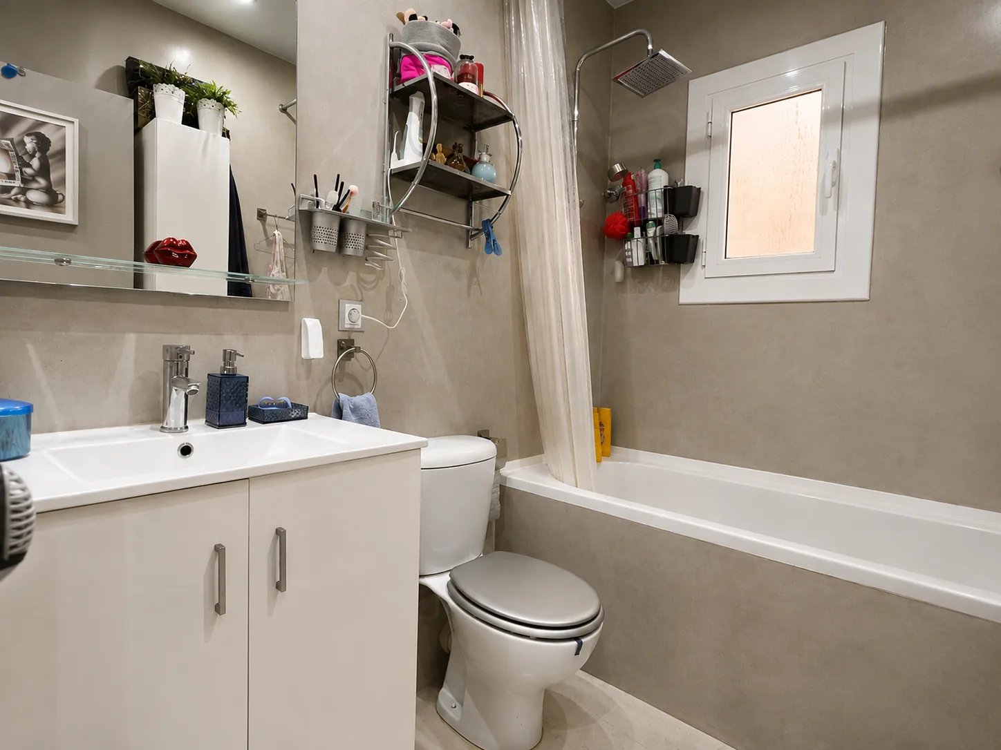 Baño completo con bañera, inodoro y mueble de lavabo