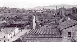 Vista de Sant Josep en 1957, con las chimeneas de las fábricas al fondo